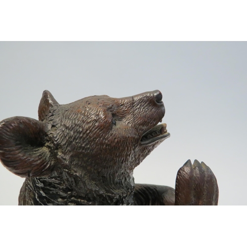 7765 - A Black Forest carved sculpture of a standing bear, 26cm high