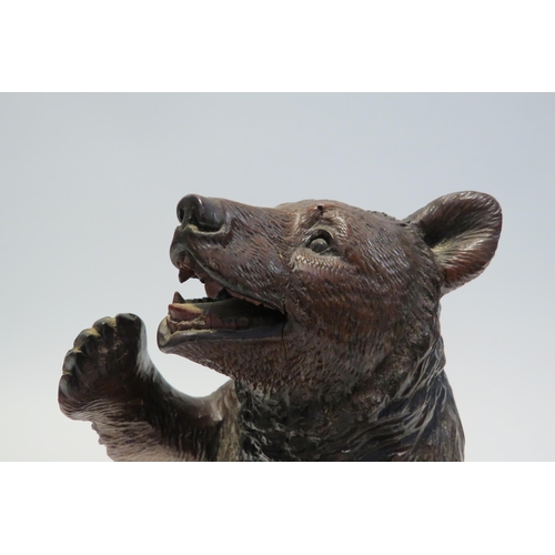 7765 - A Black Forest carved sculpture of a standing bear, 26cm high