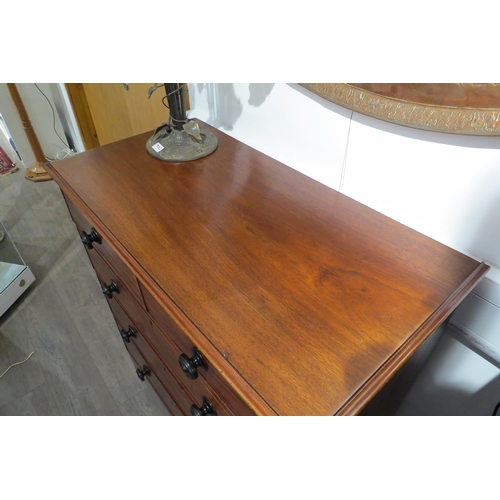 7767 - A Victorian flame mahogany chest of two short over three graduating long drawers with turned handles... 