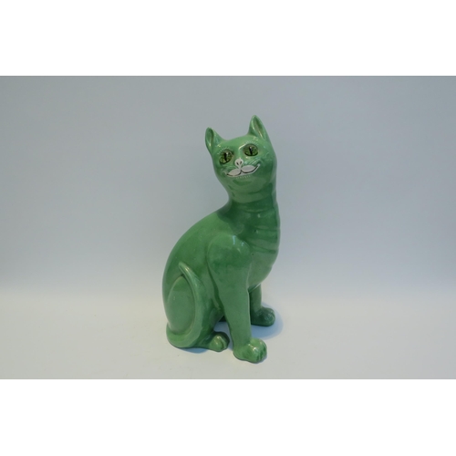 7778 - A Galle style Staffordshire cat, green glazed with glass eyes, standing 33.5cm tall