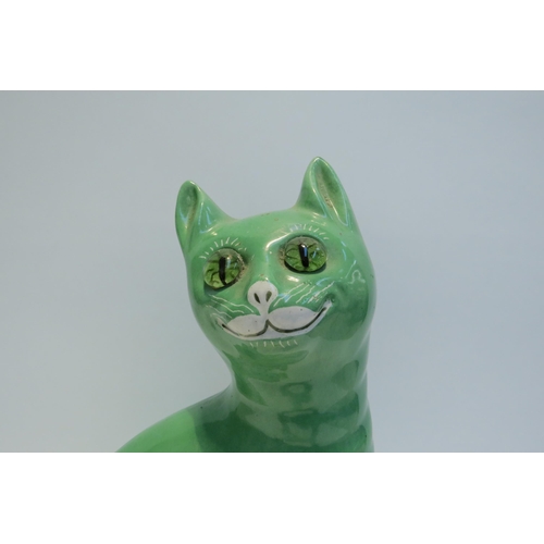 7778 - A Galle style Staffordshire cat, green glazed with glass eyes, standing 33.5cm tall