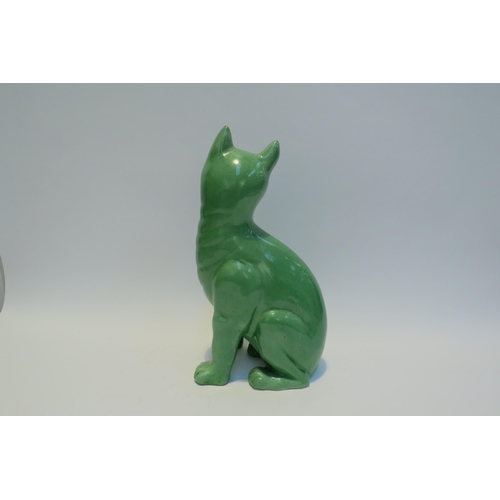 7778 - A Galle style Staffordshire cat, green glazed with glass eyes, standing 33.5cm tall