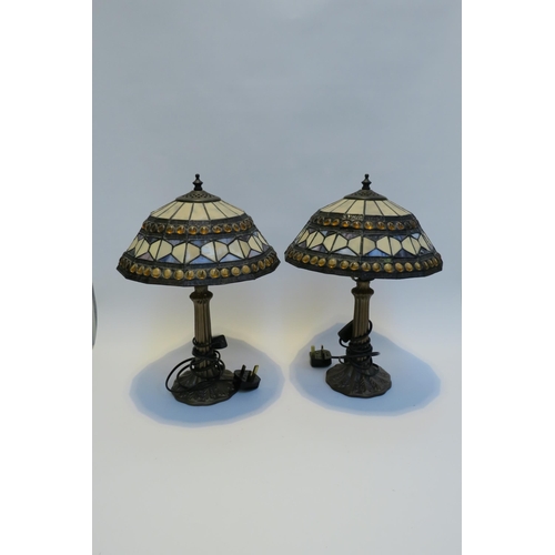 7785 - A pair of Tiffany style leaded stained glass table lamps, Art Nouveau style bronzed bases, 42cm tall