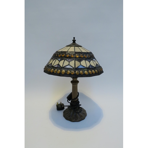 7785 - A pair of Tiffany style leaded stained glass table lamps, Art Nouveau style bronzed bases, 42cm tall