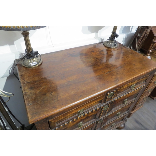 7788 - A 17th Century walnut chest of four long graduating drawers, later added beaded detail, on heavy bun... 