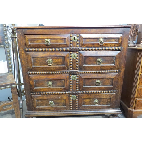 7788 - A 17th Century walnut chest of four long graduating drawers, later added beaded detail, on heavy bun... 