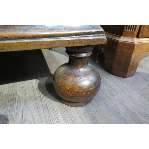 7788 - A 17th Century walnut chest of four long graduating drawers, later added beaded detail, on heavy bun... 