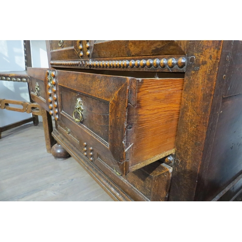 7788 - A 17th Century walnut chest of four long graduating drawers, later added beaded detail, on heavy bun... 