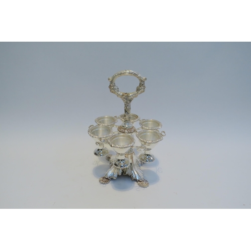 7790 - A silver plated egg cruet for six, shell form feet