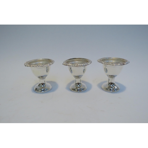 7790 - A silver plated egg cruet for six, shell form feet