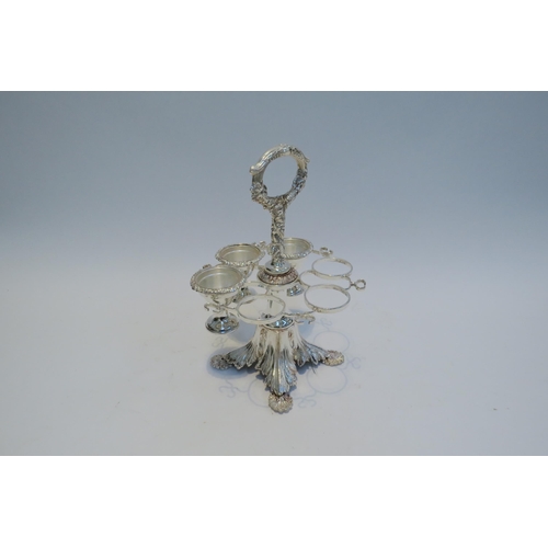 7790 - A silver plated egg cruet for six, shell form feet