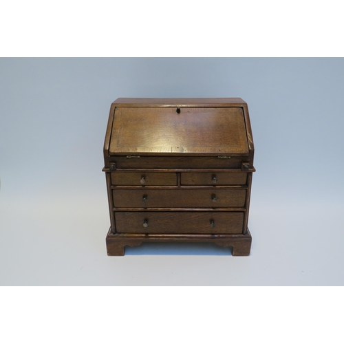 7794 - A 19th Century apprentice piece oak two small drawer over long drawers bureau fitted compartment, br... 