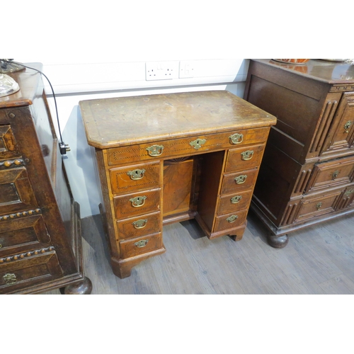 7795 - An 18th Century walnut kneehole desk, canted corner top over nine drawer and single door cabinet, he... 