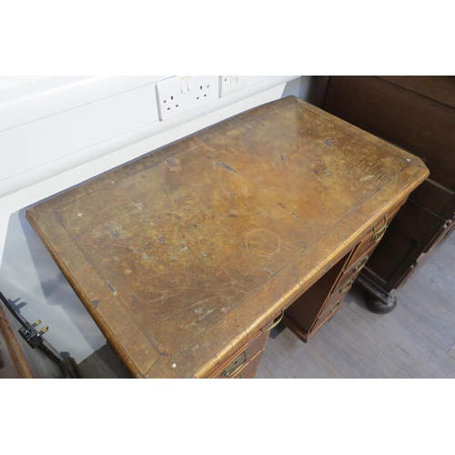 7795 - An 18th Century walnut kneehole desk, canted corner top over nine drawer and single door cabinet, he... 