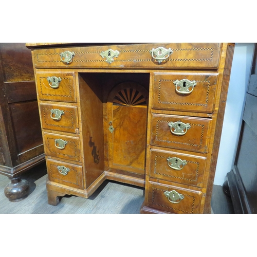 7795 - An 18th Century walnut kneehole desk, canted corner top over nine drawer and single door cabinet, he... 