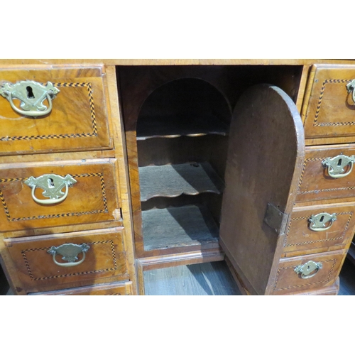 7795 - An 18th Century walnut kneehole desk, canted corner top over nine drawer and single door cabinet, he... 