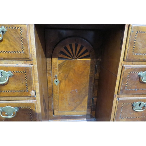 7795 - An 18th Century walnut kneehole desk, canted corner top over nine drawer and single door cabinet, he... 