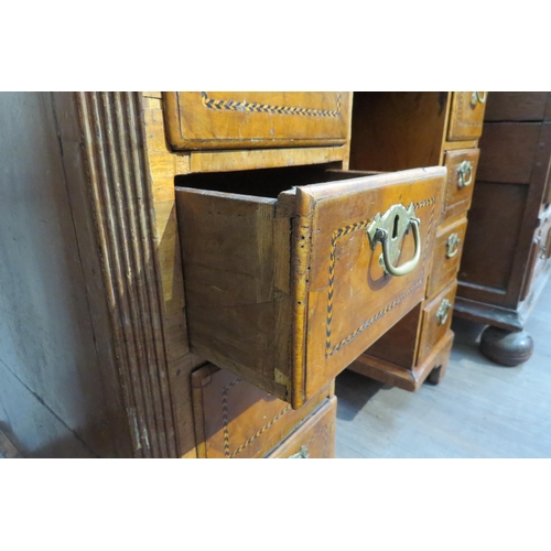 7795 - An 18th Century walnut kneehole desk, canted corner top over nine drawer and single door cabinet, he... 