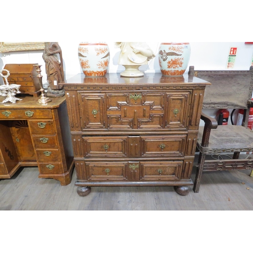 7799 - A 17th Century Jacobean oak chest of three deep long drawers, geometric mouldings, on bun feet, 96cm... 