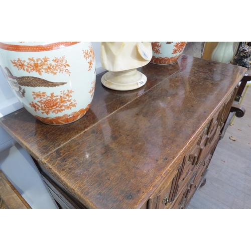 7799 - A 17th Century Jacobean oak chest of three deep long drawers, geometric mouldings, on bun feet, 96cm... 