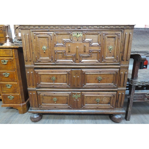 7799 - A 17th Century Jacobean oak chest of three deep long drawers, geometric mouldings, on bun feet, 96cm... 