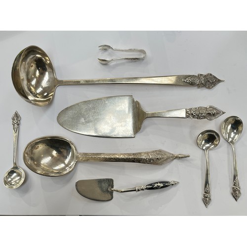 7261 - Mixed Thai Sterling and white metal serving instruments including six pieces by Alex & Co, ladle, ca... 