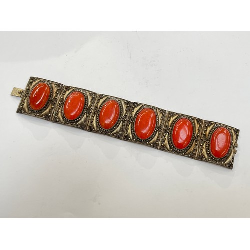 7276 - A Chinese panel bracelet with cabochon set stones, stamped silver China, 18cm long