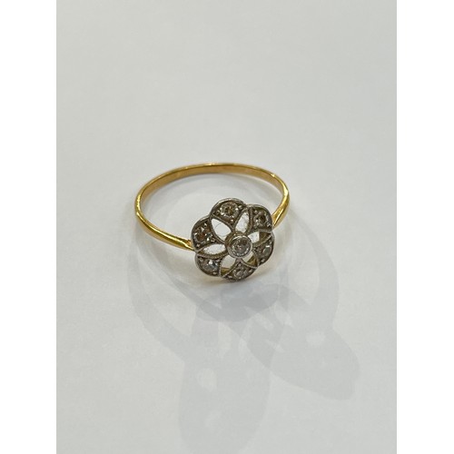 7285 - An unmarked gold platinum set diamond daisy ring with open pierced mount. Size S, 2.2g