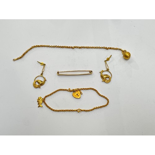 7291 - A 9ct gold bar brooch, pair of unmarked gold peacock drop earrings, charm bracelet and bracelet hung... 