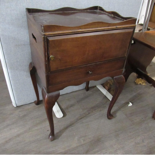 7127 - A late 19th Century mahogany night-table with galleried top above cupboard and drawer, raised on cab... 