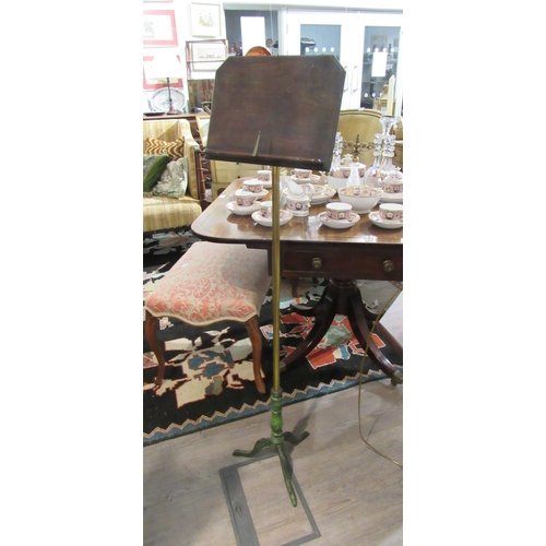 7131 - A Robertson and Colman Norwich cast tripod based music stand with brass pole, adjustable angle top, ... 