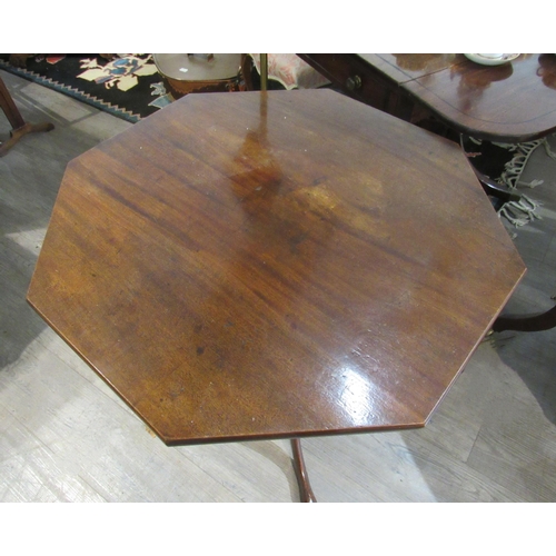 7136 - A George III mahogany octagonal tilt top tripod table, 71cm tall, 76cm diameter top