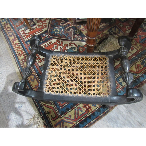 7137 - A Regency ebony scroll arm stool with cane work seat with melon fluted turned detail, 29cm x 49cm x ... 