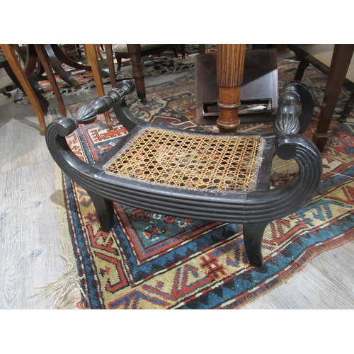 7137 - A Regency ebony scroll arm stool with cane work seat with melon fluted turned detail, 29cm x 49cm x ... 