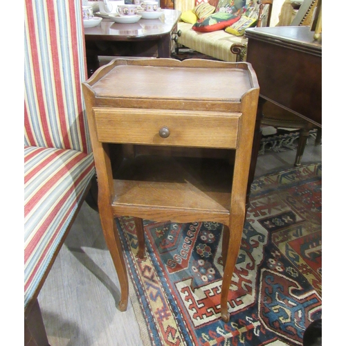 7140 - WITHDRAWN: A 20th Century French oak bedside table with drawer and recess, raised on cabriole legs, ... 