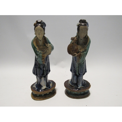 7159 - A pair of late 19th Century / early 20th Century glazed Shiwan pottery figures both with areas of da... 