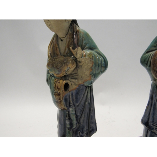 7159 - A pair of late 19th Century / early 20th Century glazed Shiwan pottery figures both with areas of da... 