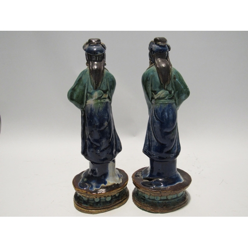 7159 - A pair of late 19th Century / early 20th Century glazed Shiwan pottery figures both with areas of da... 