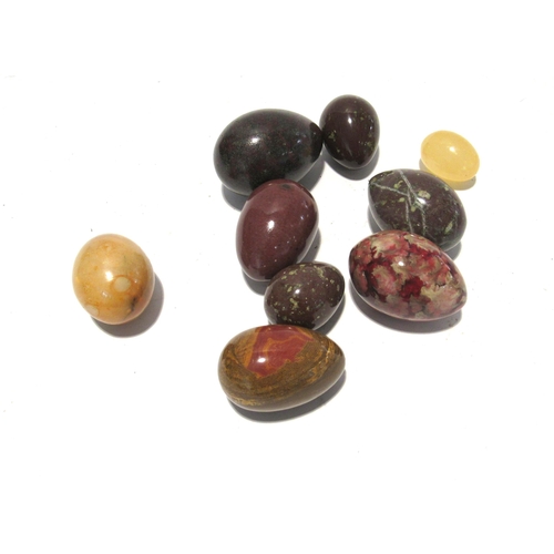 7170 - Seven polished stone eggs and another, all of varying sizes, largest 7cm, smallest 4cm