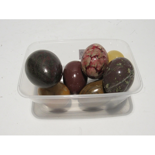 7170 - Seven polished stone eggs and another, all of varying sizes, largest 7cm, smallest 4cm