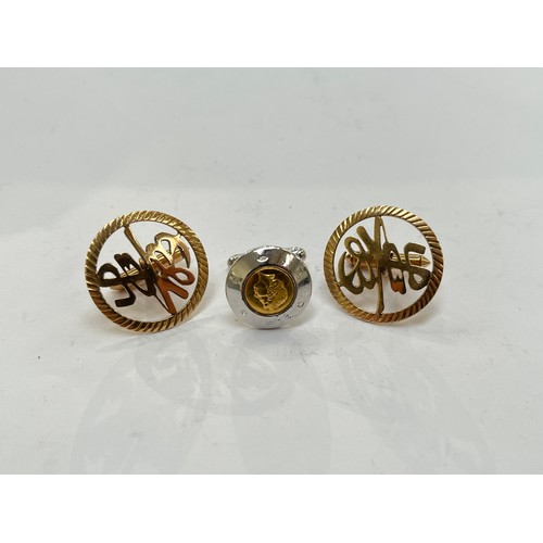 7301 - A pair of 14k gold cufflinks with Chinese symbol detail, (10g) and a single silver Queen Elizabeth I... 