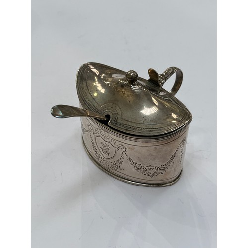 7306 - An Alexander Field silver mustard pot, chased foliate swags and central dragon and crown cartouche, ... 