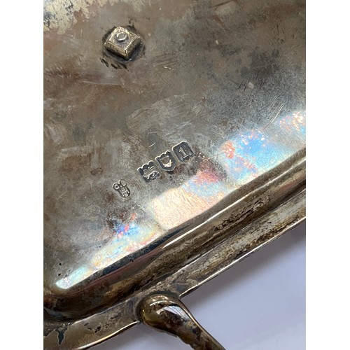 7309 - An Edwardian silver desk stand, twin handle, gadrooned border, central inkwell, raised on feet, make... 