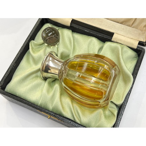 7311 - An amber and clear glass scent bottle with sterling silver collar, glass stopper, 11cm tall