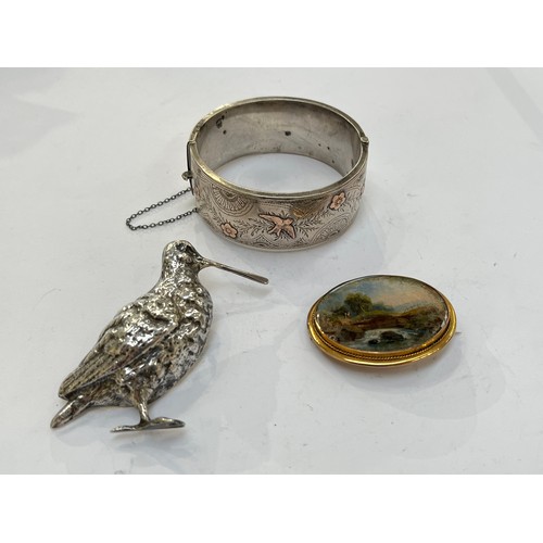 7312 - A silver brooch in the form of a snipe 6.5cm tall, silver bangle and brooch with landscape scene, 4.... 