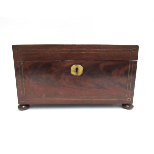 7801 - A George III mahogany rectangular tea caddy inset with brass. Raised on bun feet with associated mix... 