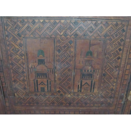 7802 - A 19th Century marquetry and parquetry inlaid chest, the front with minarets and architectural panel... 