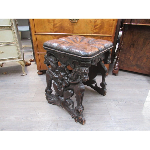 7804 - A 19th Century walnut stool carved with lions