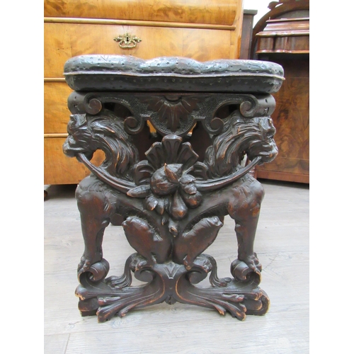 7804 - A 19th Century walnut stool carved with lions