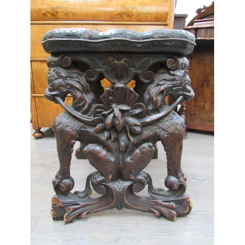 7804 - A 19th Century walnut stool carved with lions